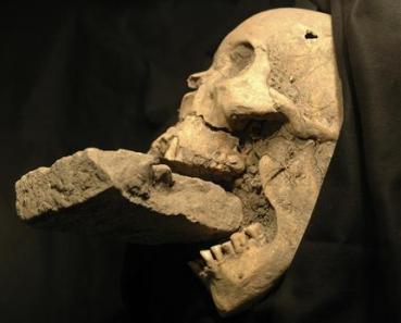 Skull with brick in mouth
